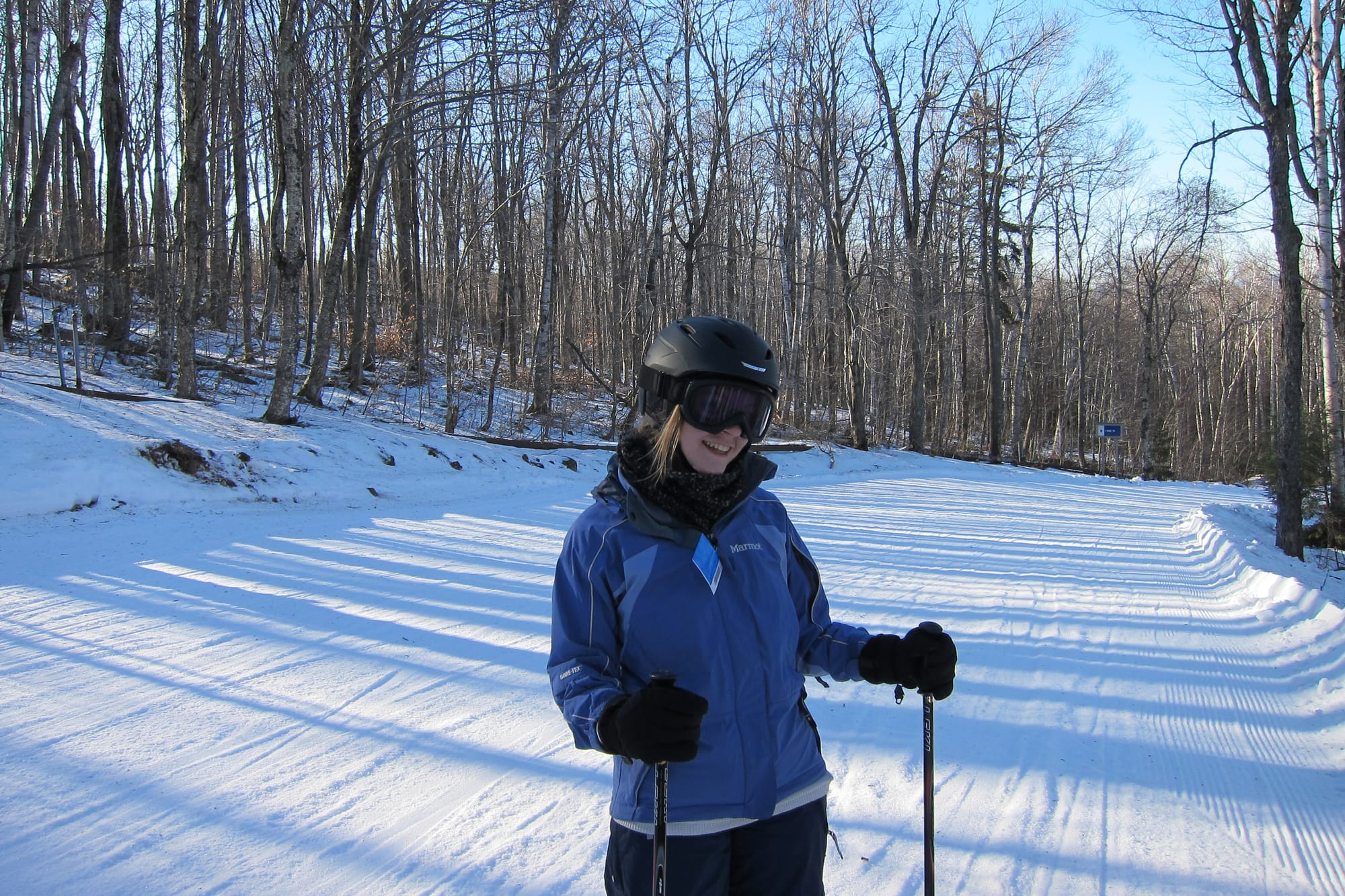 A photo of the author as a teenager, wearing her ski gear, standing on a ski slope