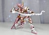 A pink gunpla kneels with one hand behind its head and the other hand holding a crossbow.